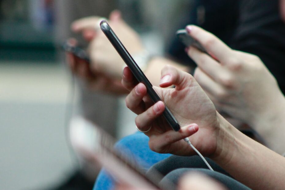 People holding smartphones; people spend a lot of time on their mobile