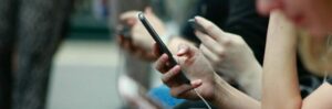 People holding smartphones; people spend a lot of time on their mobile